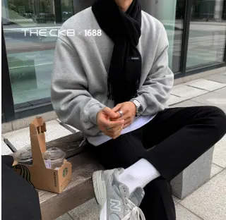 マフラーをしてベンチに座る男性